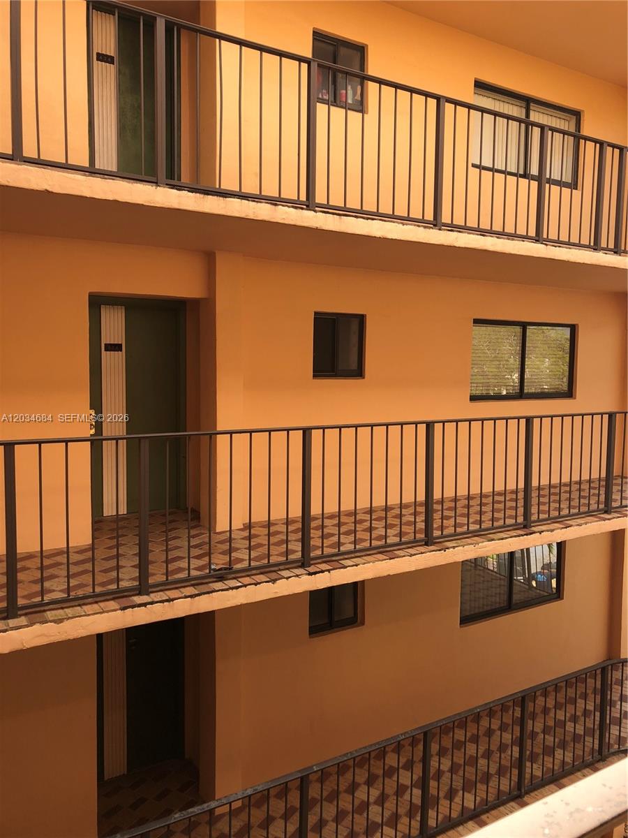 An exterior view of a multi-story apartment building with open walkways and metal railings — 8400 SW 133rd Ave Rd # 324, Miami FL 33183, MIAMI, FL