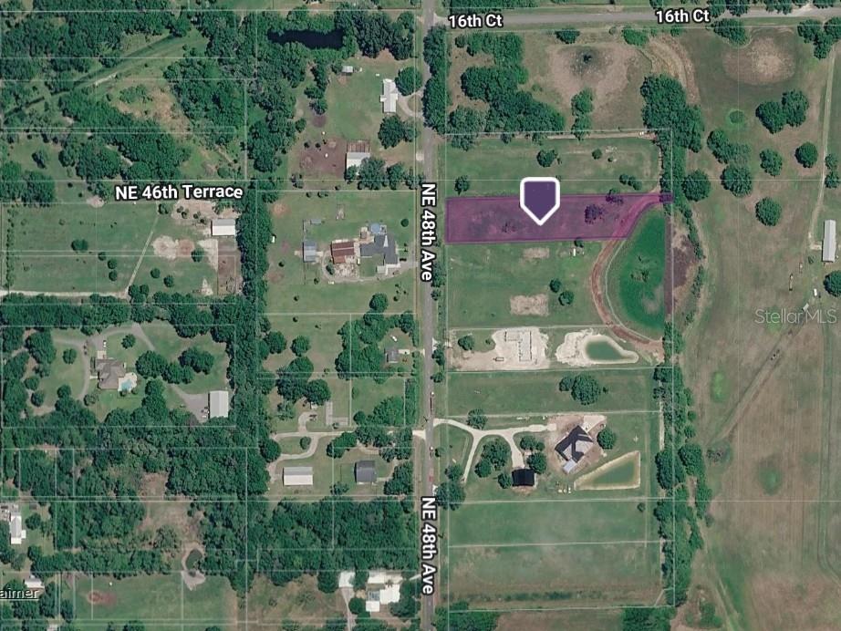 This aerial map shows a rectangular parcel of land highlighted in purple along a road — 1376 NE 48TH AVENUE, OKEECHOBEE, FL