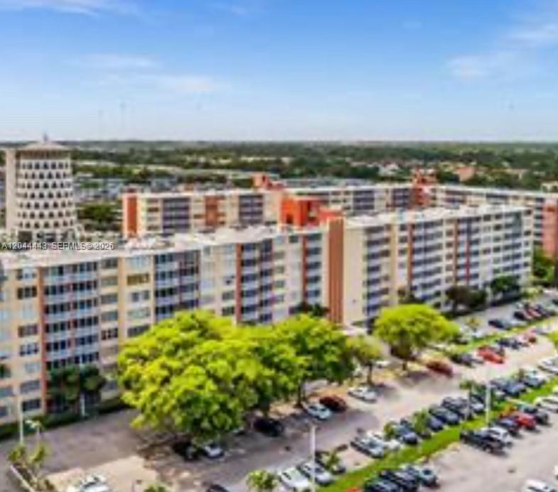An aerial view shows a large multi-story apartment complex with a parking lot below — 1780 NE 191st St # 2, Miami FL 33179, MIAMI, FL