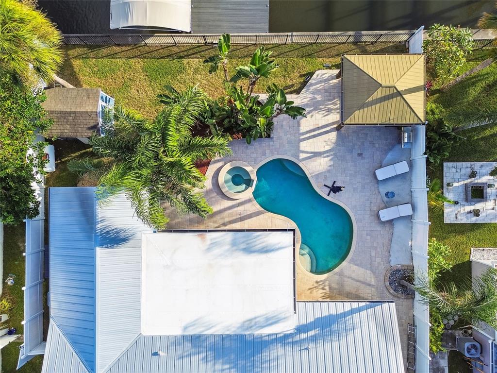 An aerial view shows a backyard with a swimming pool, spa, patio, and gazebo — 8708 THORNWOOD LANE, TAMPA, FL