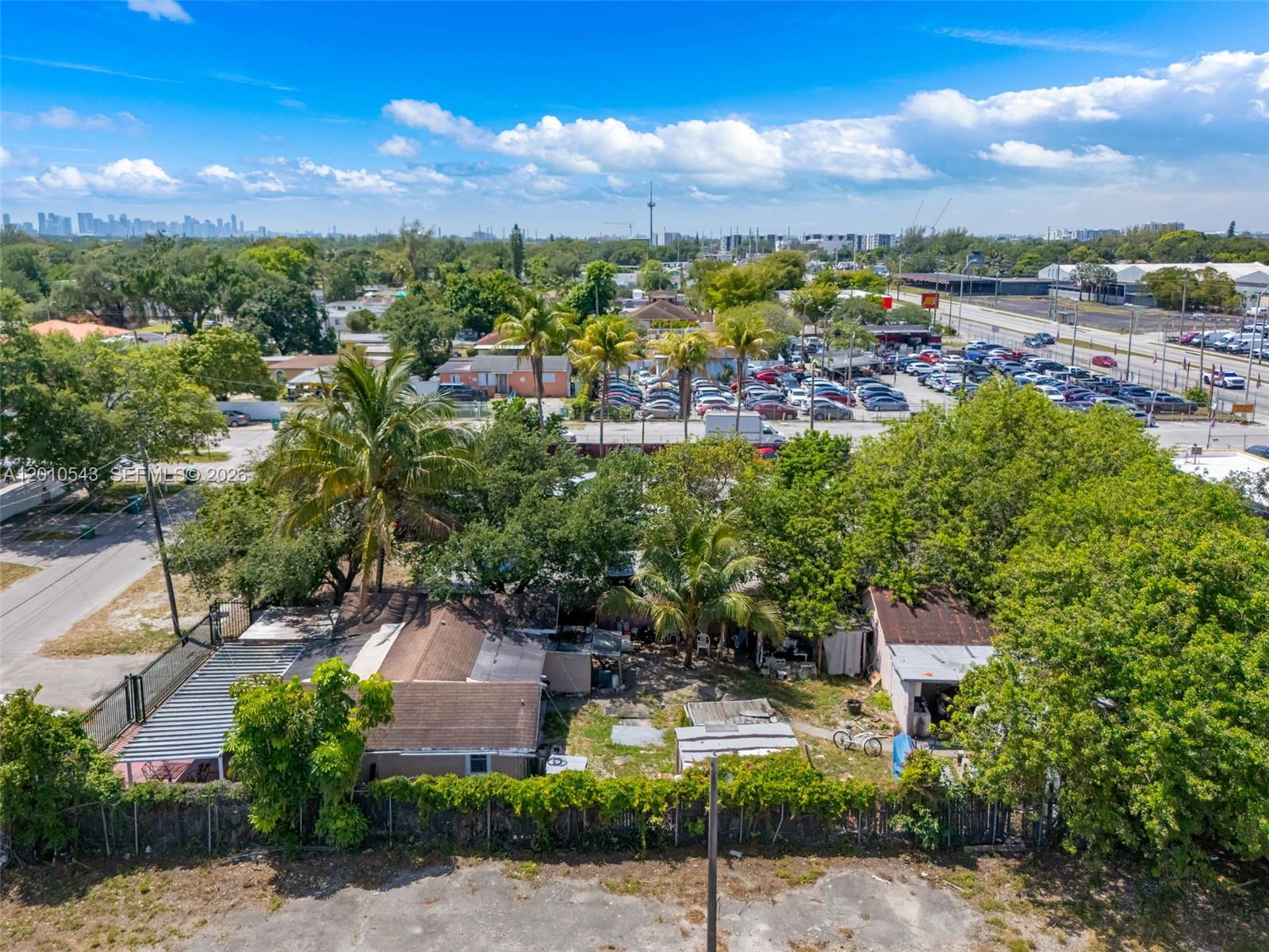 An aerial view shows a residential property with two small houses and trees — 9422 NW 26th Ave, Miami FL 33147, MIAMI, FL