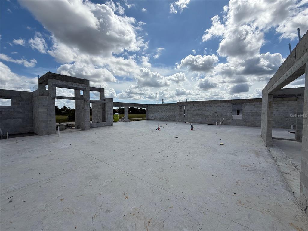 An unfinished concrete block structure with an open floor plan under a cloudy sky — 324 NW 31ST PLACE, CAPE CORAL, FL