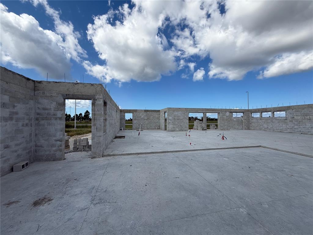 A concrete slab foundation and unfinished block walls of a house under construction — 324 NW 31ST PLACE, CAPE CORAL, FL