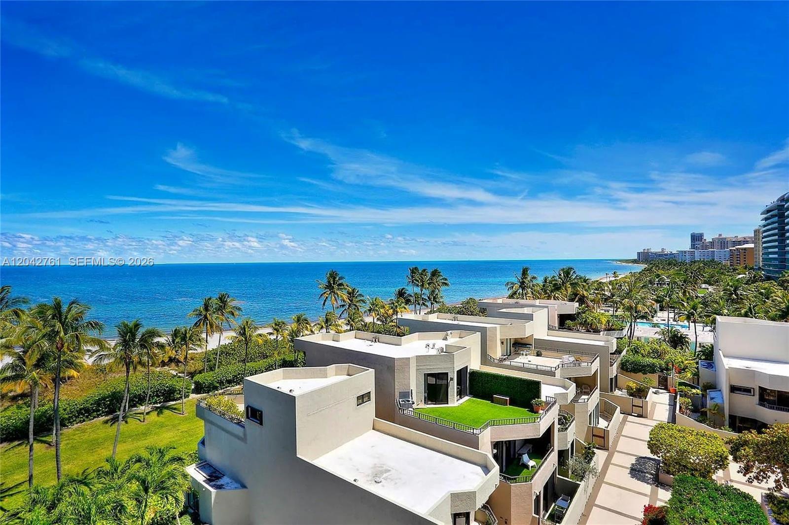 An elevated view shows modern multi-level townhomes with green roofs overlooking a beach and ocean — 201 Crandon Blvd # 643, Key Biscayne FL 33149, KEY BISCAYNE, FL