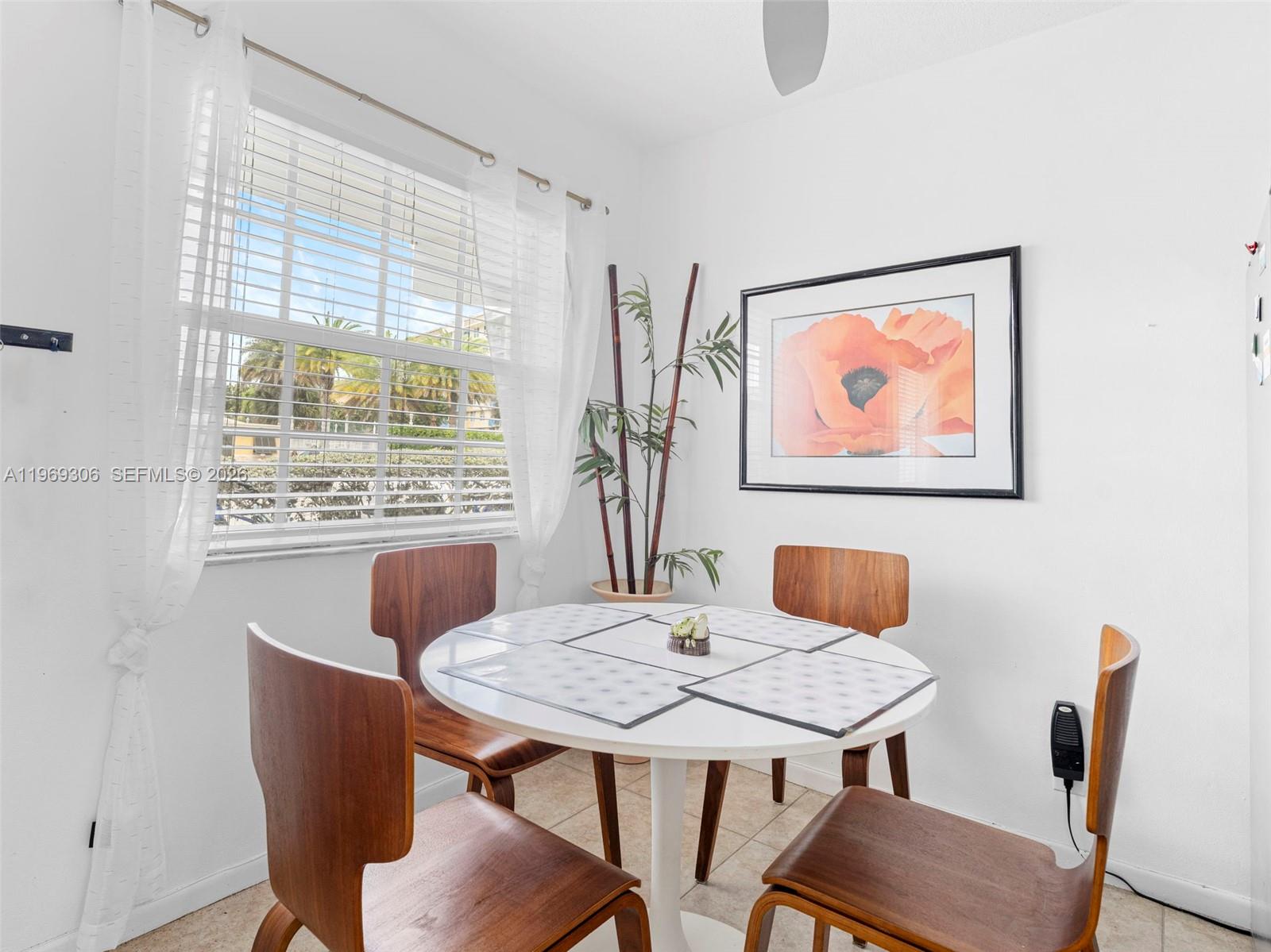 A dining area features a white round table, four wooden chairs, and a window — 3220 NE 10th St # 5, Pompano Beach FL 3306, POMPANO BEACH, FL