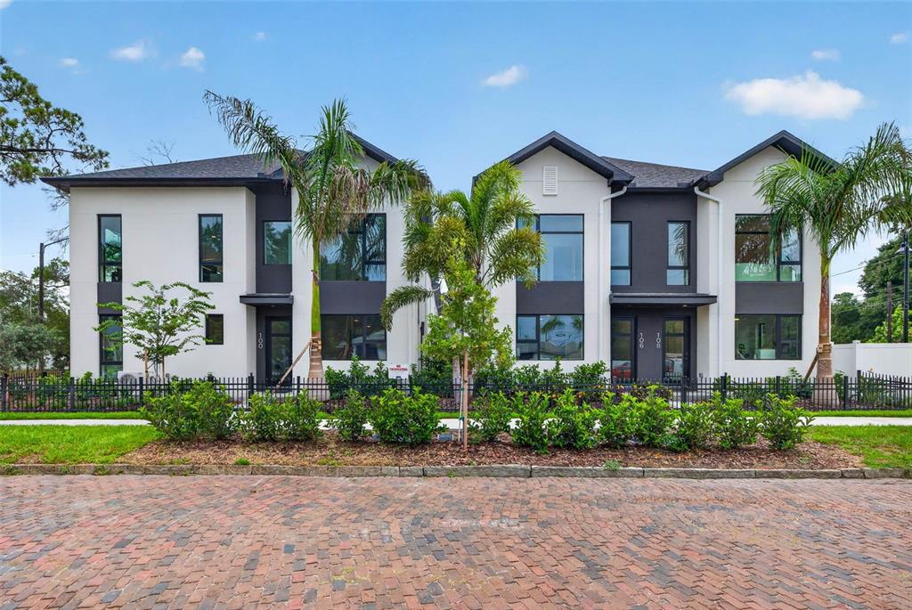 A modern two-story duplex building with white stucco walls, dark trim, and palm trees — 3603 1ST AVENUE N, ST PETERSBURG, FL