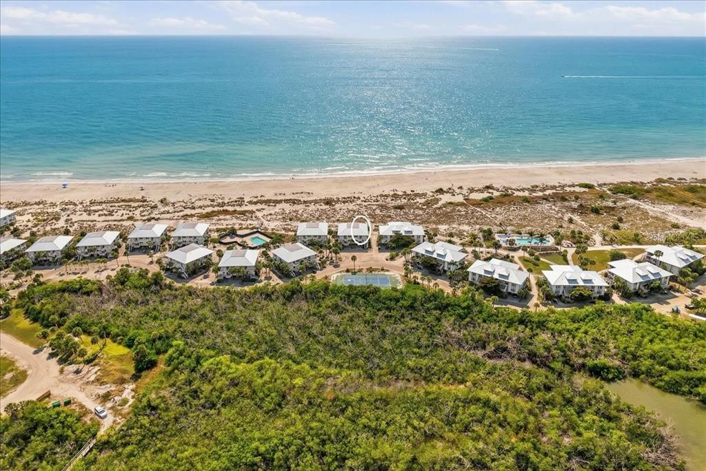 An aerial view shows a coastal condominium complex with multiple buildings, pools, and tennis courts — 7466 PALM ISLAND DRIVE UNIT 2922, PLACIDA, FL
