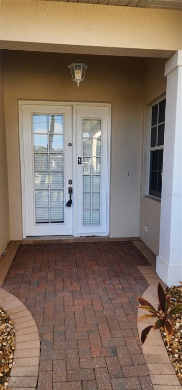 A front entryway features a white double door with glass panes and a brick walkway — 197 TROPICANA DRIVE UNIT 1512, PUNTA GORDA, FL