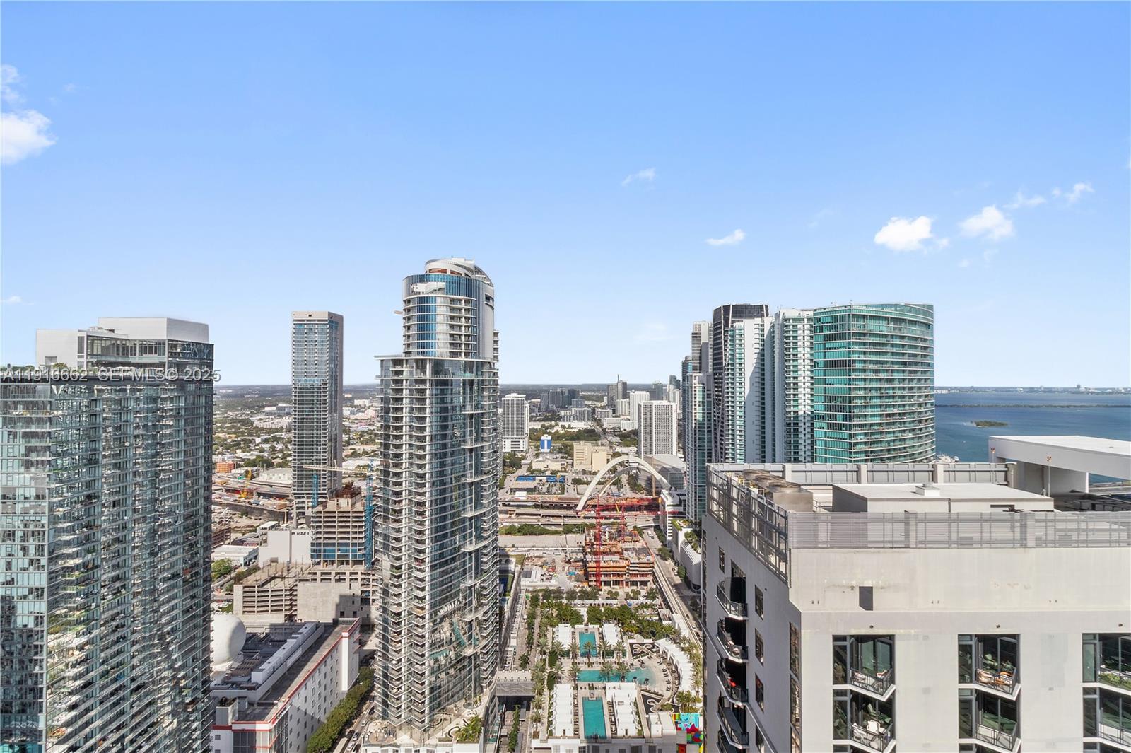 An elevated view of a dense urban skyline featuring multiple high-rise buildings and a bay — 159 NE 6th St # 4713, Miami FL 33132, MIAMI, FL