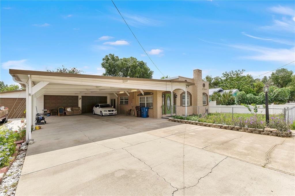 A single-story house with a large attached carport and a concrete driveway — 205 TENNESSEE STREET, HAINES CITY, FL