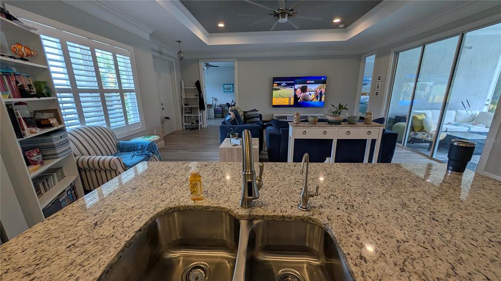 A single-story house with a gray exterior, solar panels, and an attached two-car garage — 3369 BILLBERRY STREET, NORTH PORT, FL