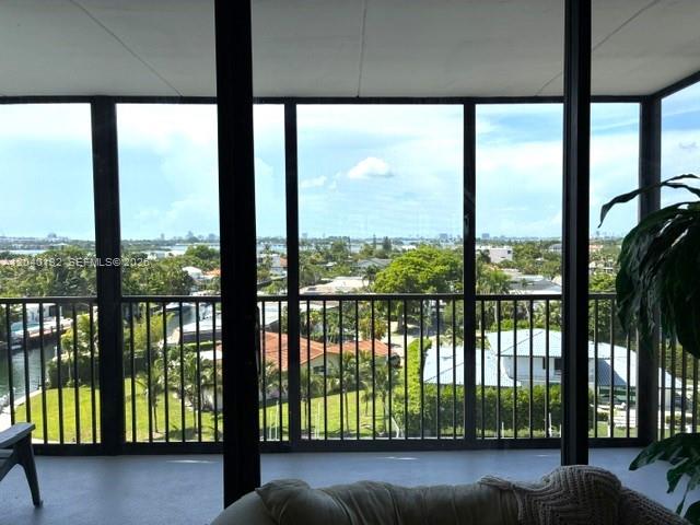 A view of a residential neighborhood and water from a screened-in balcony — 2500 NE 135th St # C611, North Miami FL 33181, NORTH MIAMI, FL
