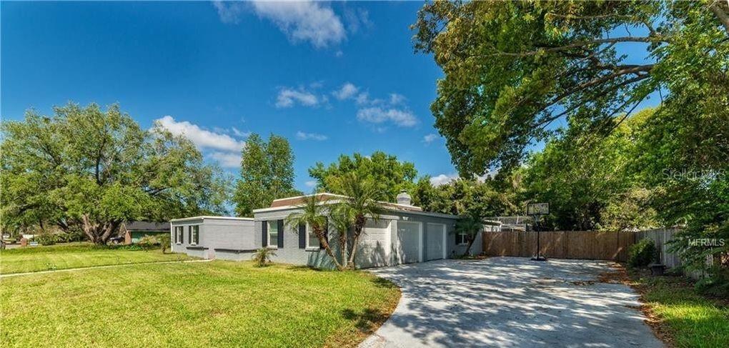 A gray house with a concrete driveway and a basketball hoop sits on a lawn — 130 VARIETY TREE CIRCLE, ALTAMONTE SPRINGS, FL