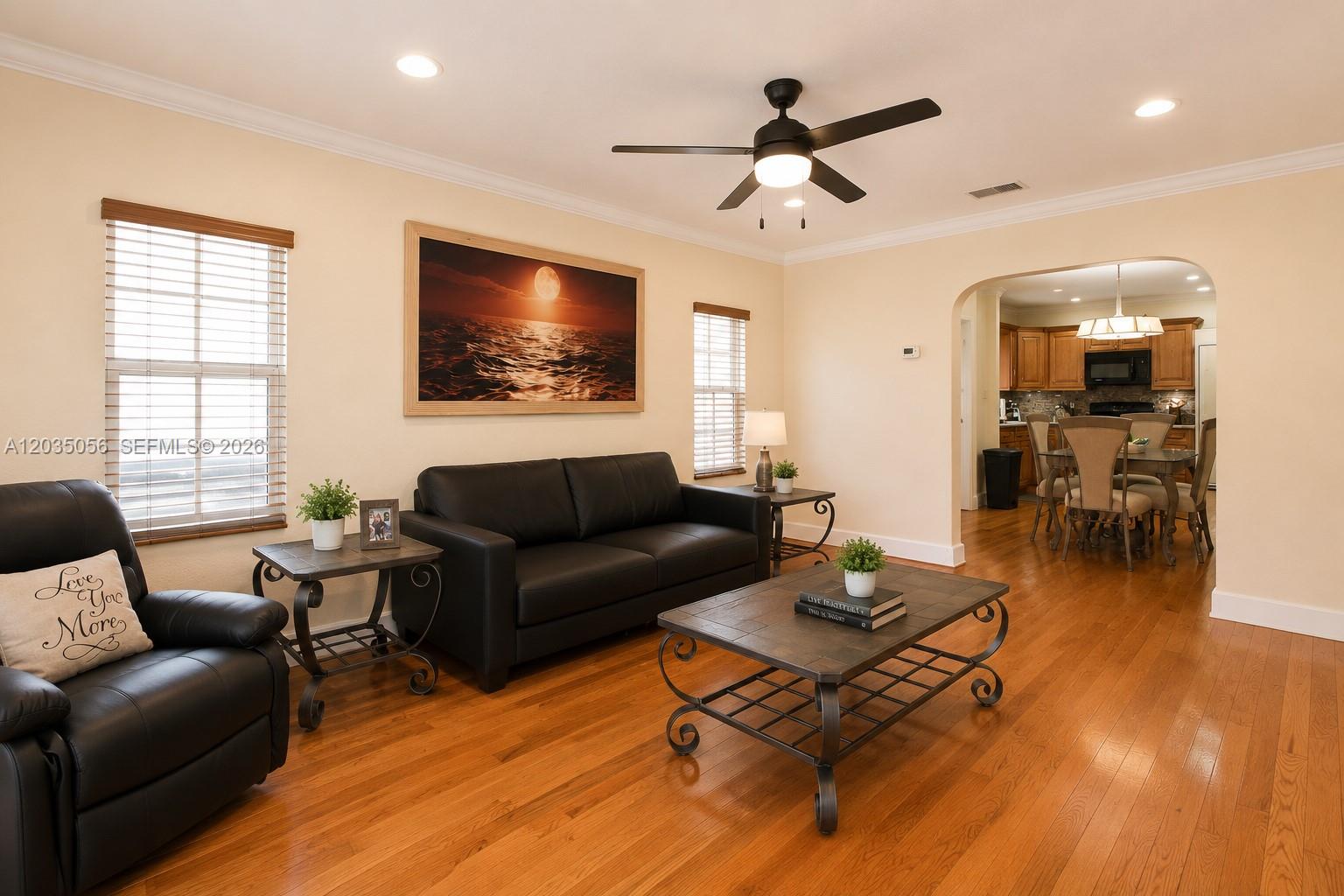 A living room features a black leather sofa, a coffee table, and hardwood flooring — 316 S 24th Ave, Hollywood FL 33020, HOLLYWOOD, FL
