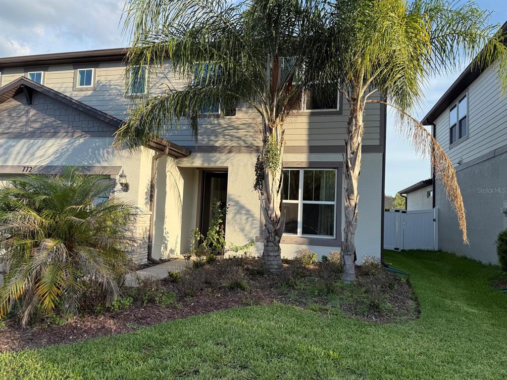 A two-story house exterior with palm trees, a front entrance, and a grassy lawn — 772 PARSONS MOORING COURT, SEFFNER, FL
