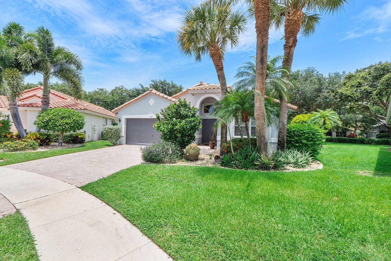 A single-story house with a gray garage, palm trees, and a green lawn — 6643 Sherbrook Drive, Boynton Beach FL 33437, BOYNTON BEACH, FL
