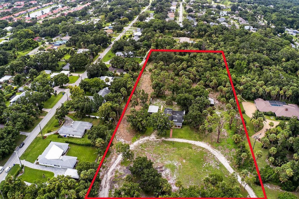 An aerial view shows a house situated on a large, wooded lot outlined in red — 5240 20th Street, Vero Beach FL 32966, VERO BEACH, FL