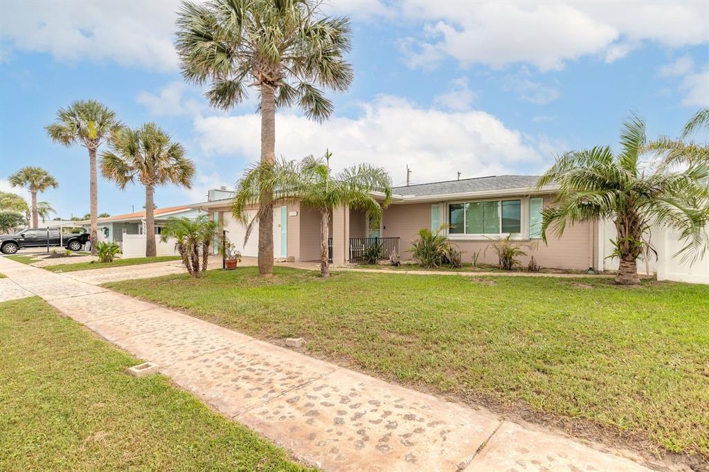 A single-story house with a tan exterior, palm trees, and a concrete driveway — 2315 BONNIE VIEW DRIVE, ORMOND BEACH, FL
