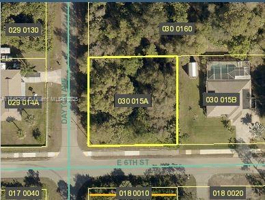 This is an aerial map view showing a vacant residential lot outlined in yellow — 1701 E 6th St, Lehigh Acres FL 33972, LEHIGH ACRES, FL