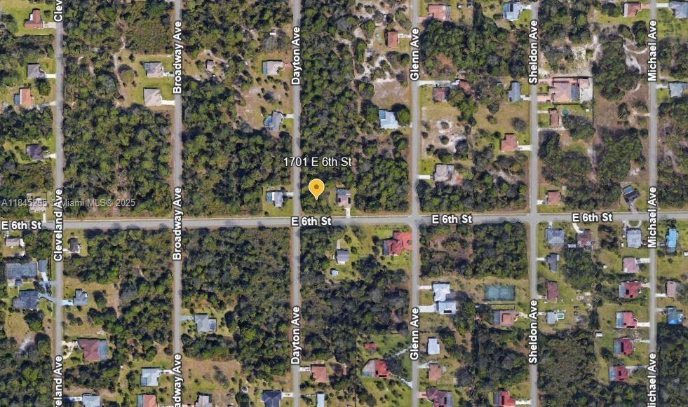 This is an aerial map view showing a residential property located at a street intersection — 1701 E 6th St, Lehigh Acres FL 33972, LEHIGH ACRES, FL