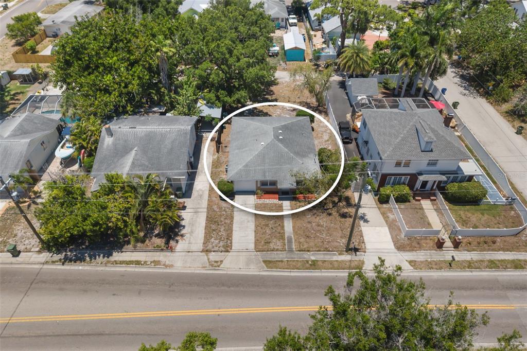 An aerial view shows a single-story house with a gray hip roof and driveway — 808 26TH STREET W, BRADENTON, FL