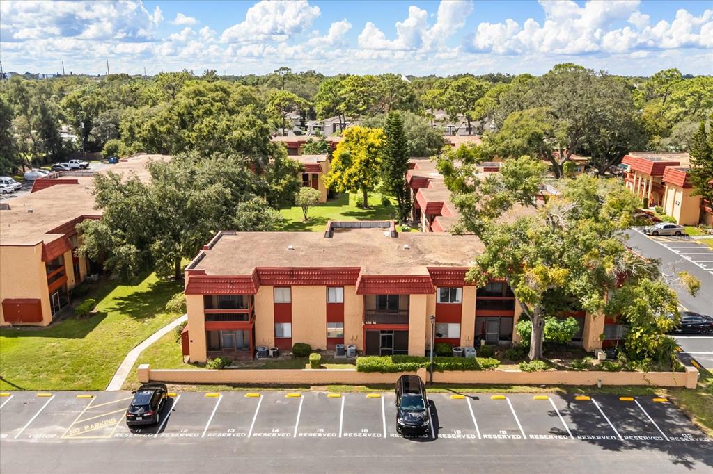 An aerial view shows a two-story apartment complex with a parking lot in front — 2858 N POWERS DRIVE UNIT 123, ORLANDO, FL