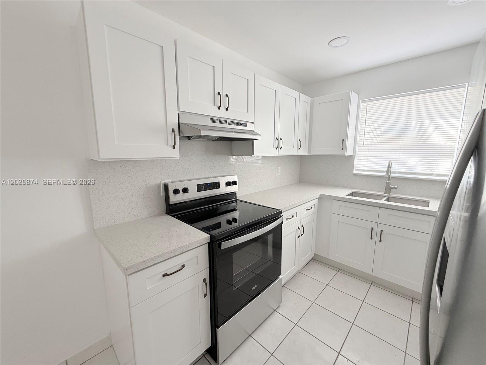 A kitchen features white cabinets, stainless steel appliances, and light-colored countertops — 2645 SW 28th Ct # 2645, Miami FL 33133, MIAMI, FL