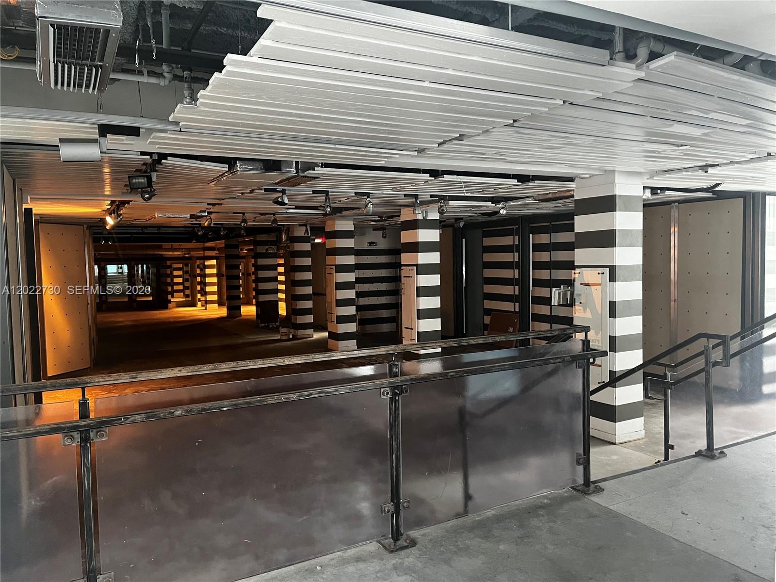 An unfinished commercial space features black-and-white striped columns and a slatted white ceiling — 826 Collins Ave, Miami Beach FL 33139, MIAMI BEACH, FL