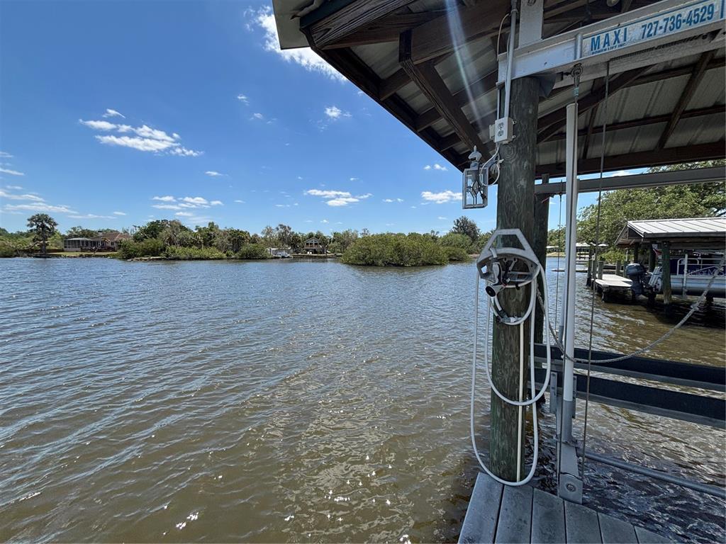 A view of a waterfront area from under a covered boat dock with a hose — 9922 ALAVISTA DRIVE, GIBSONTON, FL