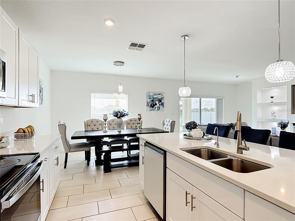 A living room features a large sectional sofa, a fireplace, and built-in display shelving — 246 ZIRCON ROAD, KISSIMMEE, FL