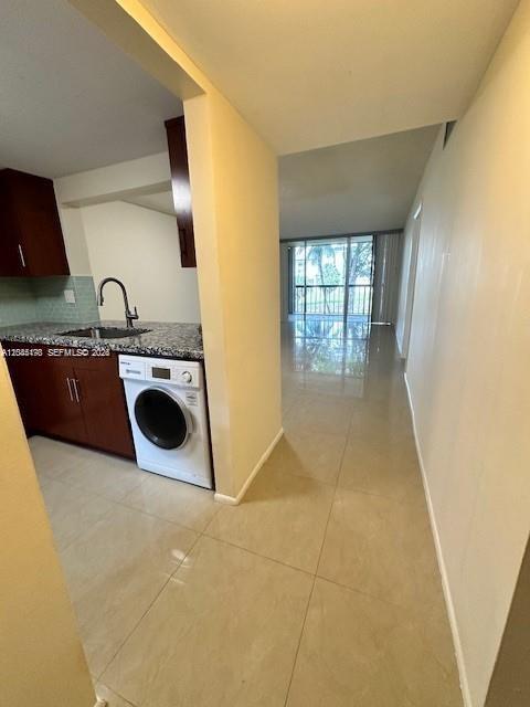A kitchen features dark wood cabinets, granite countertops, a stainless steel sink, and tile backsplash — 10845 SW 112th Ave # 211, Miami FL 33176, MIAMI, FL