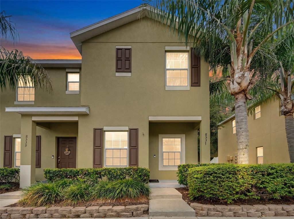 A bathroom features a glass-enclosed shower, a toilet, and a vanity with a granite countertop — 8537 BRUSHLEAF WAY, TAMPA, FL