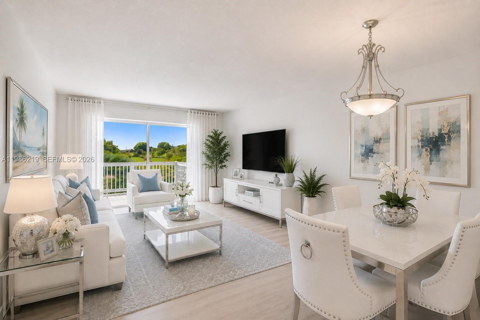 A bright, open-concept living and dining area features white furniture, a television, and balcony access — 4800 Hillcrest Ln # 408, Hollywood FL 33021, HOLLYWOOD, FL