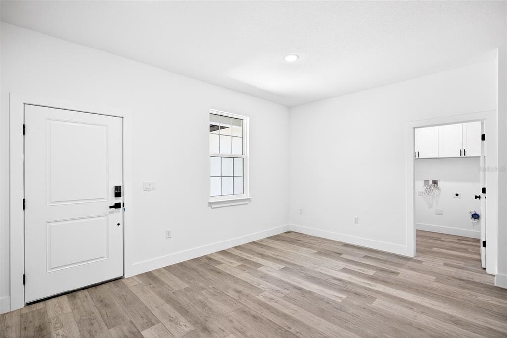 An empty room with white walls, recessed lighting, a window, and wood-look flooring — 193 SANTA FE STREET, PORT CHARLOTTE, FL