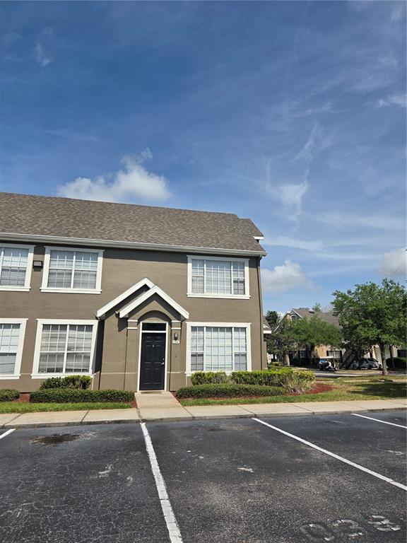 A two-story brown apartment building with a black front door and white-trimmed windows — 9141 LEE VISTA BOULEVARD UNIT 308, ORLANDO, FL