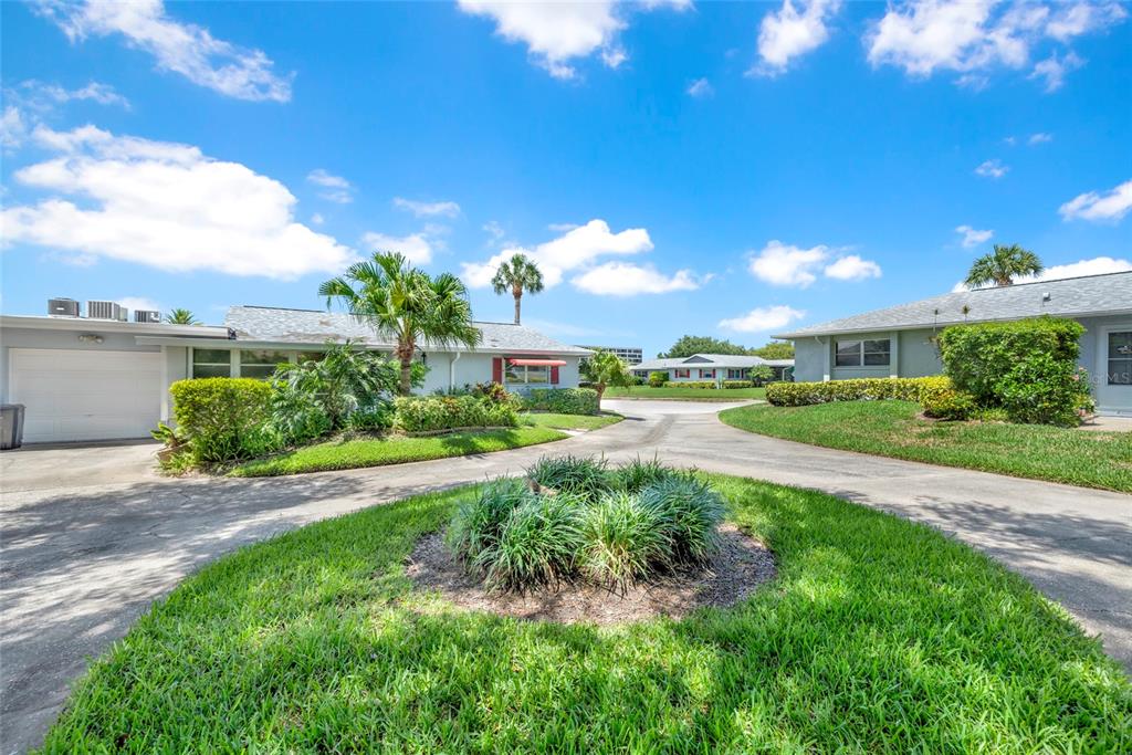 A view of the exterior of two single-story residential buildings with a shared driveway — 1608 WHITEBRIDGE DRIVE UNIT B, PALM HARBOR, FL