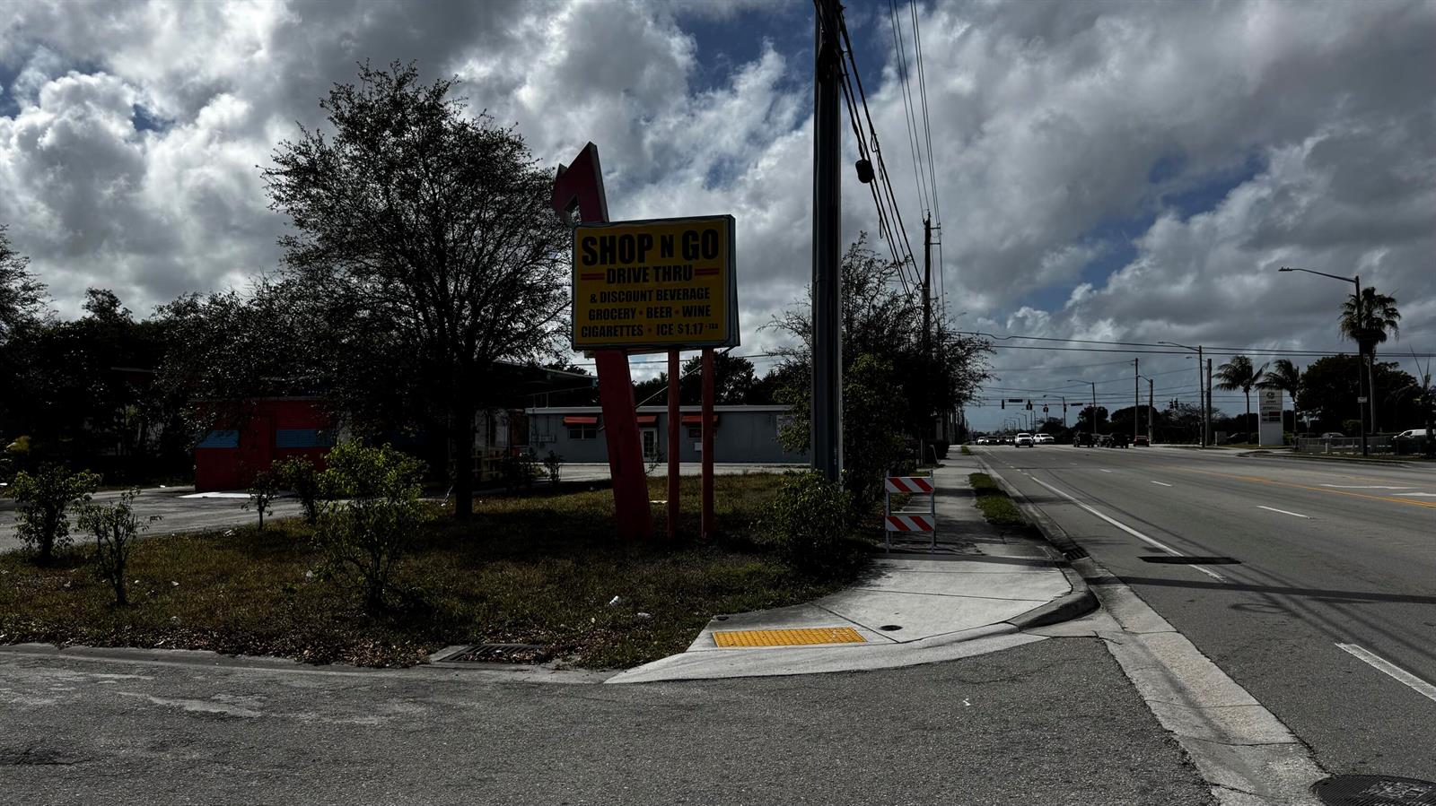 A Shop N Go convenience store sign stands near a road and sidewalk — 3263 Sierra Drive, Palm Springs FL 33461, PALM SPRINGS, FL