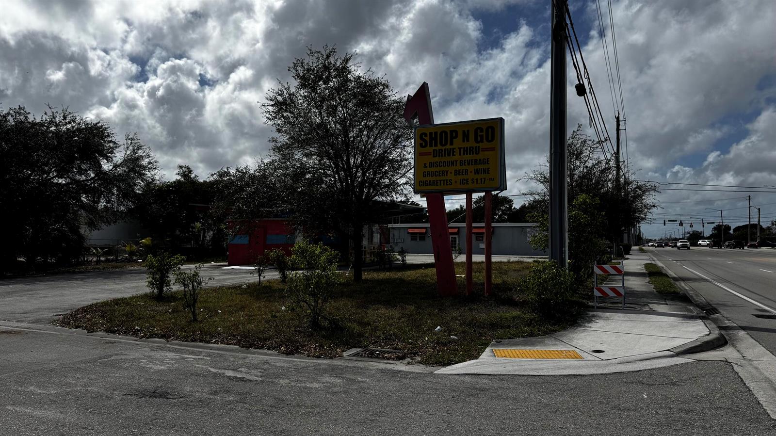 A Shop N Go drive-thru convenience store sits on a corner lot with a parking area — 3263 Sierra Drive, Palm Springs FL 33461, PALM SPRINGS, FL