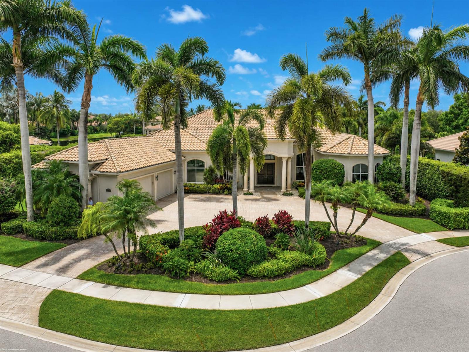 A single-story house with a tiled roof and palm trees sits behind a circular driveway — 12809 Mizner Way, Wellington FL 33414, WELLINGTON, FL