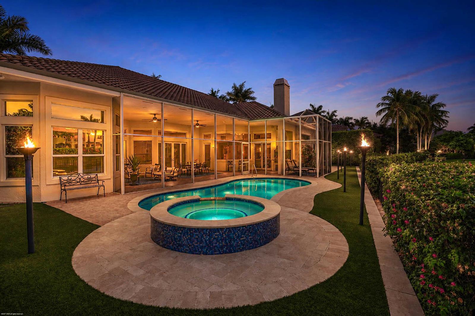 A backyard features a swimming pool, a circular hot tub, and a screened-in patio at dusk — 12809 Mizner Way, Wellington FL 33414, WELLINGTON, FL