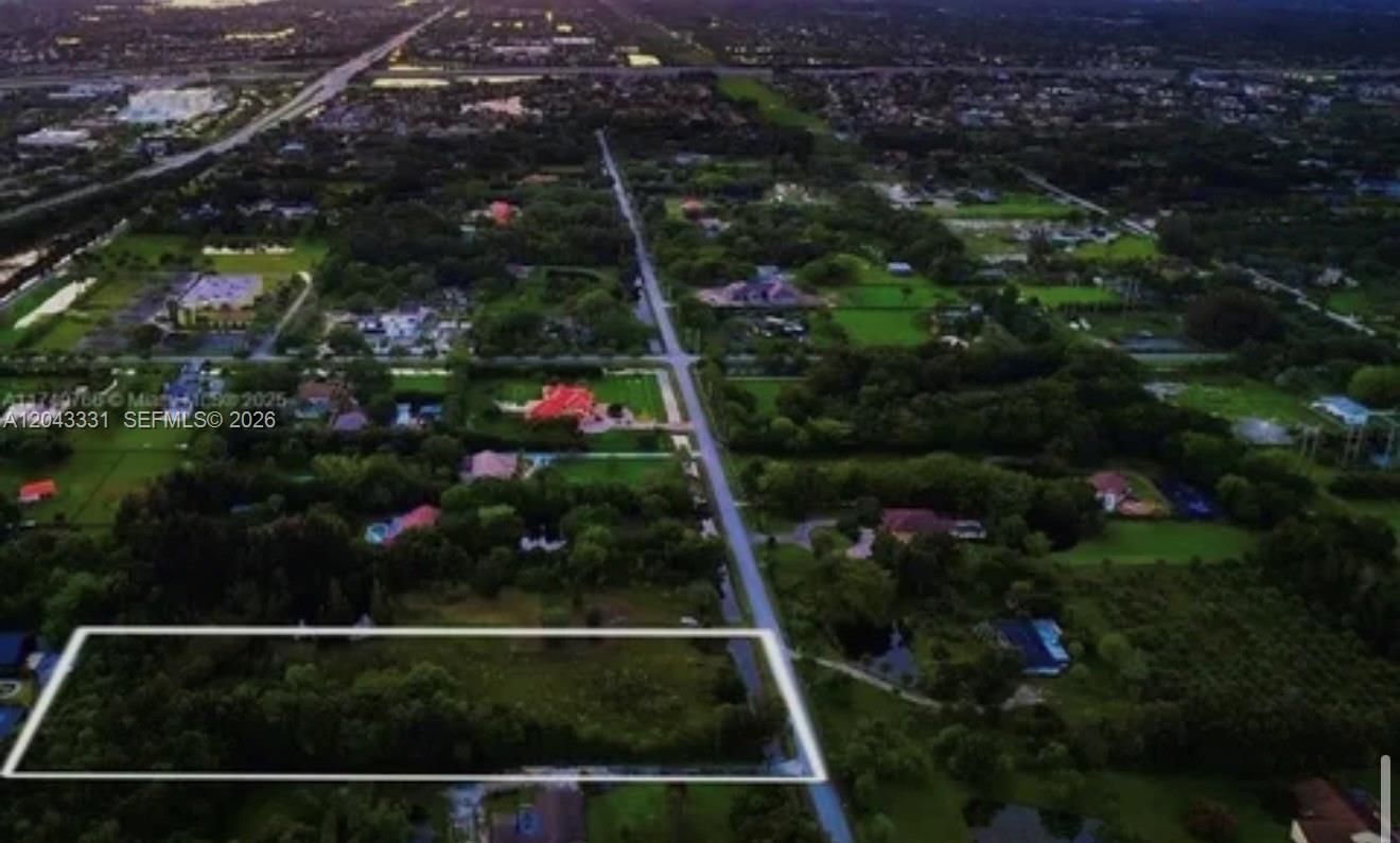 An aerial view shows a rectangular, undeveloped plot of land surrounded by trees and houses — 14010 Mustang Trl, Southwest Ranches FL 33330, SOUTHWEST RANCHES, FL