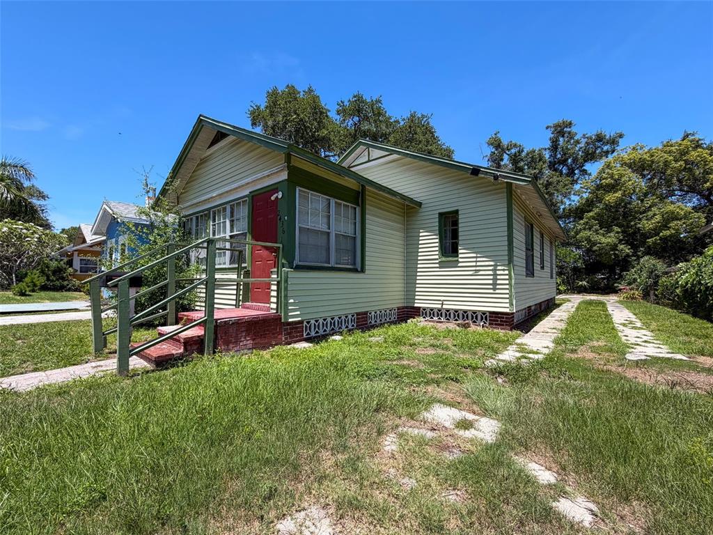 A light green, single-story house with a red front door and a concrete driveway — 2436 10TH STREET S, ST PETERSBURG, FL