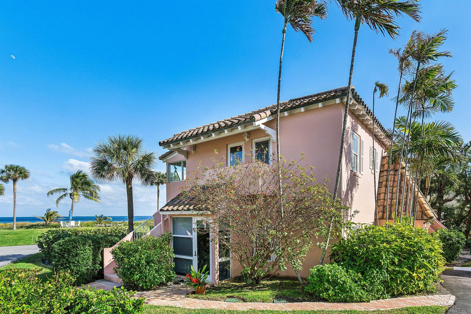 A two-story pink stucco house with a tile roof sits near a grassy beach area — 2075 S Ocean Boulevard # 3d, Delray Beach FL 33483, DELRAY BEACH, FL