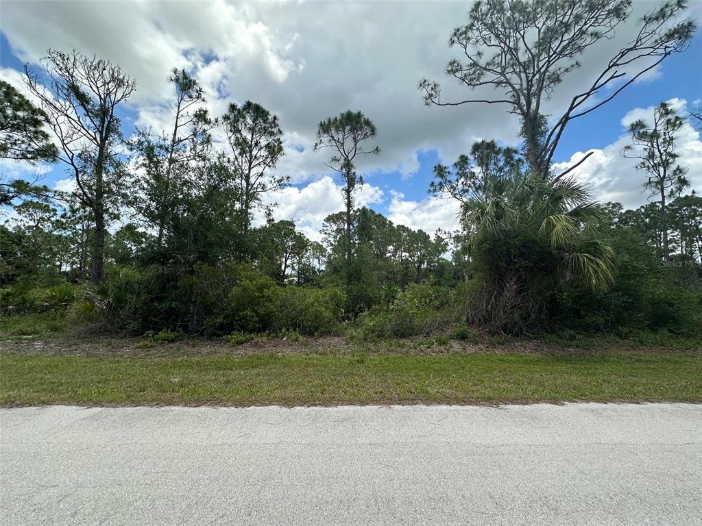 This aerial map view shows a residential area with houses, wooded lots, and several roads — 26468 HAPSBURG ROAD, PUNTA GORDA, FL