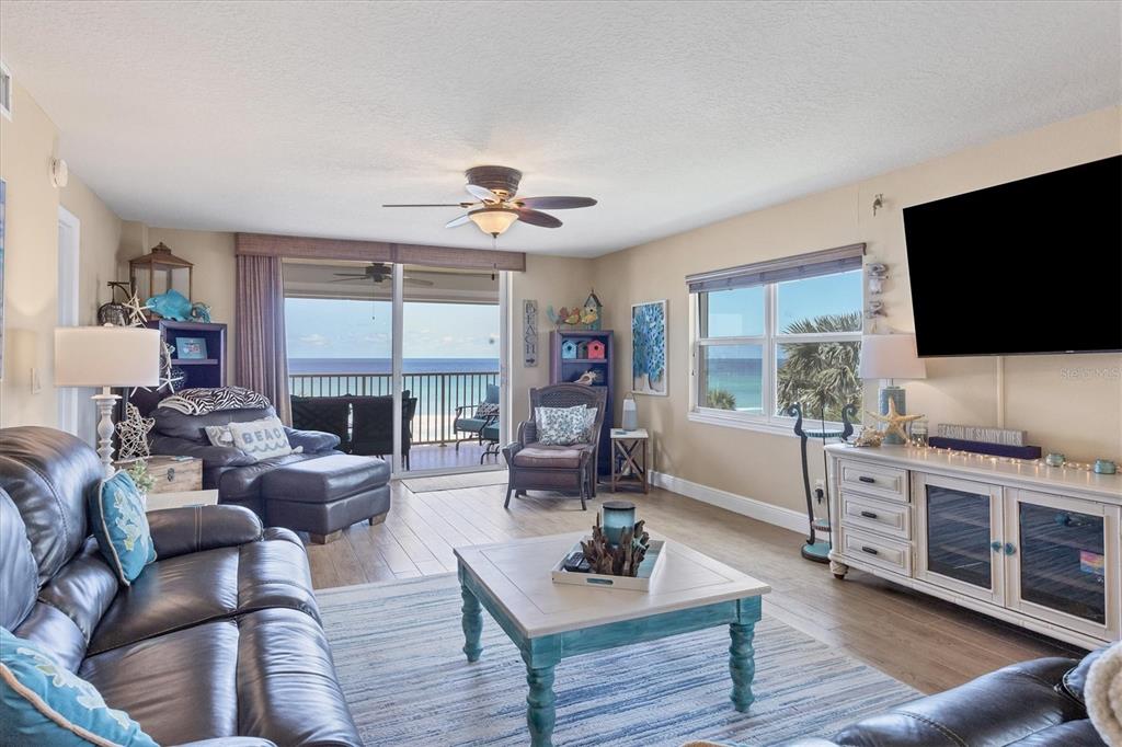 A living room with leather furniture, a coffee table, and a balcony overlooking the ocean — 4325 GULF OF MEXICO DRIVE UNIT 408, LONGBOAT KEY, FL