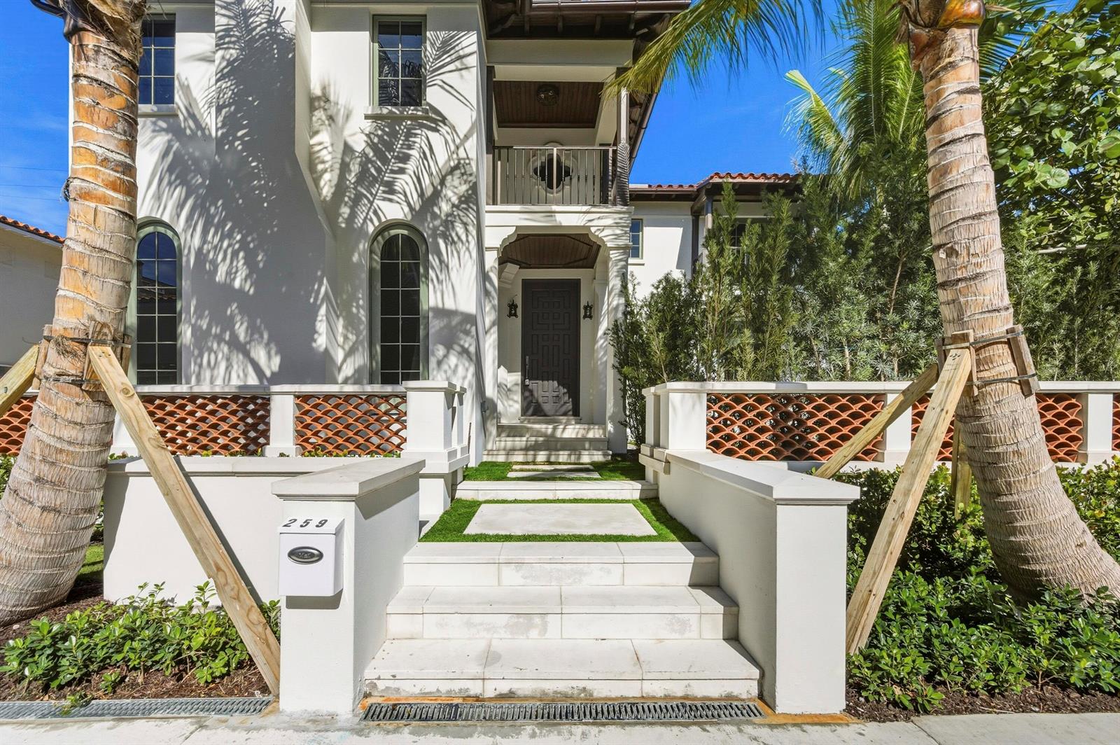 A white two-story house features a gated entrance with stone steps and palm trees — 259 Oleander Avenue, Palm Beach FL 33480, PALM BEACH, FL