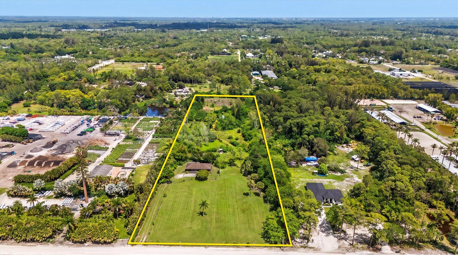 An aerial view shows a large, rectangular residential lot with a house and green lawn — 1814 A Road, FL 33470, FL