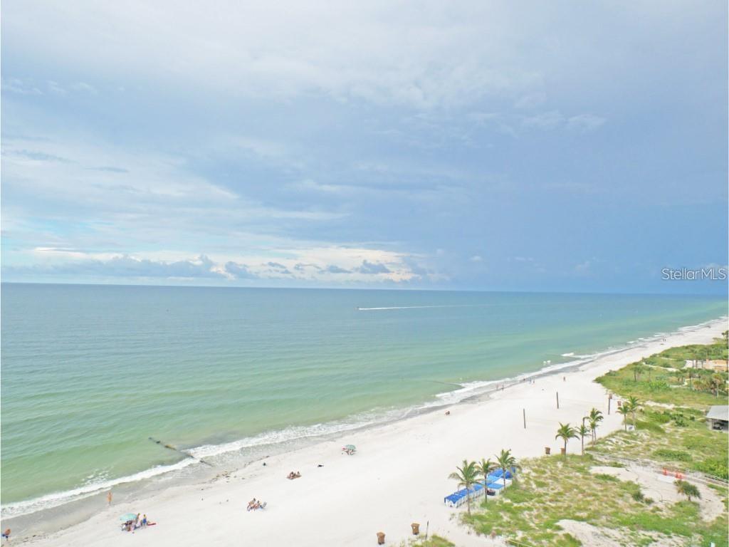 An aerial view of a white sand beach along the ocean under a cloudy sky — 15000 GULF BOULEVARD UNIT 1108, MADEIRA BEACH, FL