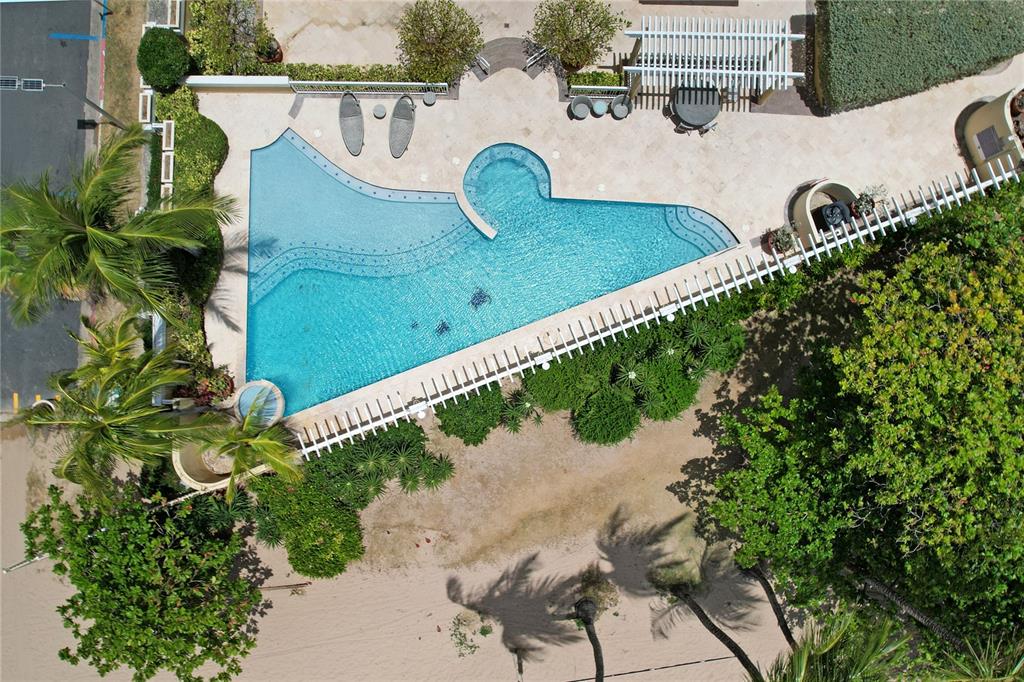 An aerial view of a sandy beach fronting a city skyline with several high-rise buildings — Carrion Court #6 CARRION COURT PLAYA STREET UNIT 103, SAN JUAN, PR