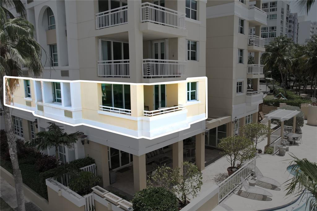 An exterior view of a multi-story building highlighting a second-floor balcony with glass doors — Carrion Court #6 CARRION COURT PLAYA STREET UNIT 103, SAN JUAN, PR